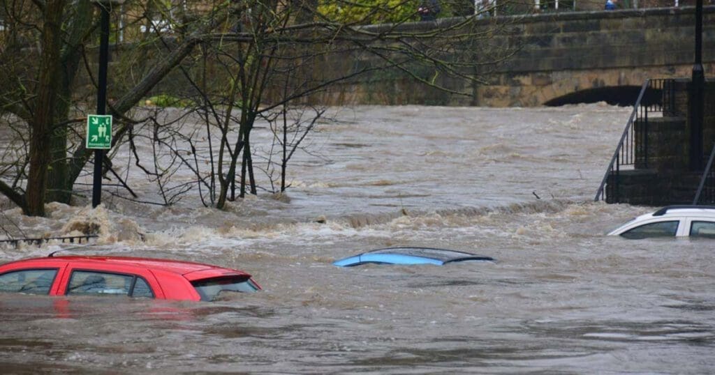 Three cars trapped in flood water up to their roofs