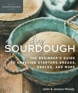 A round sourdough loaf in a basket with "DIY Sourdough" text overlay.
