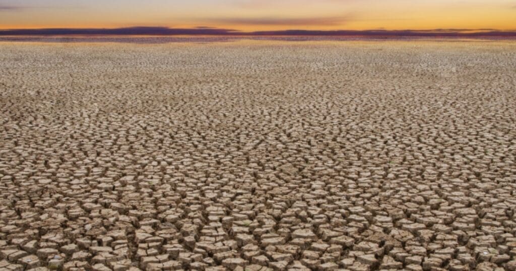Dried ground under an orange sky