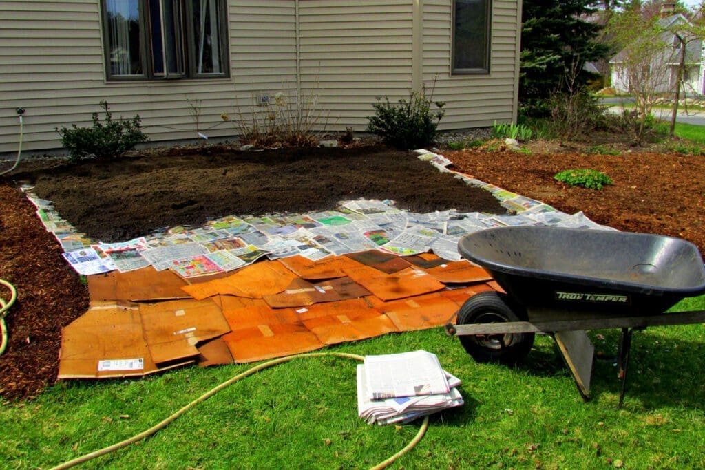 A garden being set up with cardboard, newspaper and soil in layers