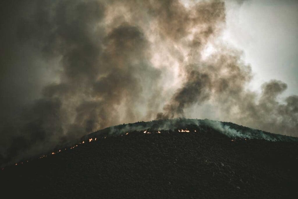 Wildfires at night with smouldering ash.