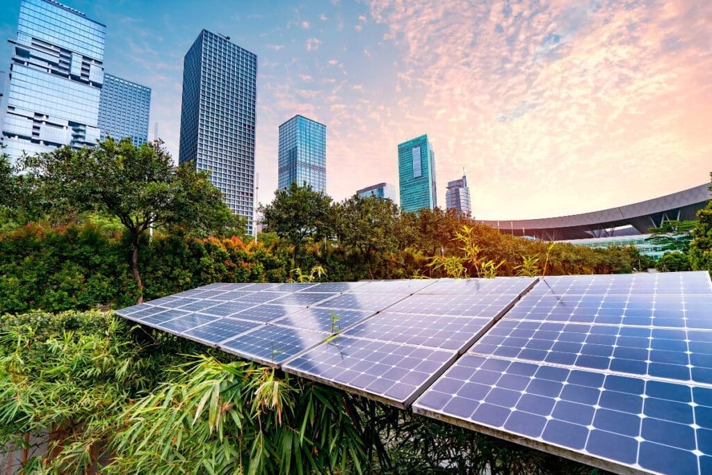 Solar panels on the ground surrounded by skyscrapers