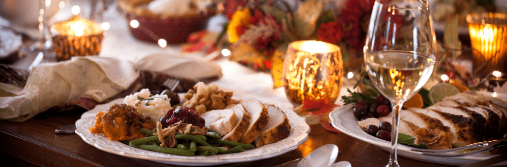Table set for dinner party with turkey and glasses of water