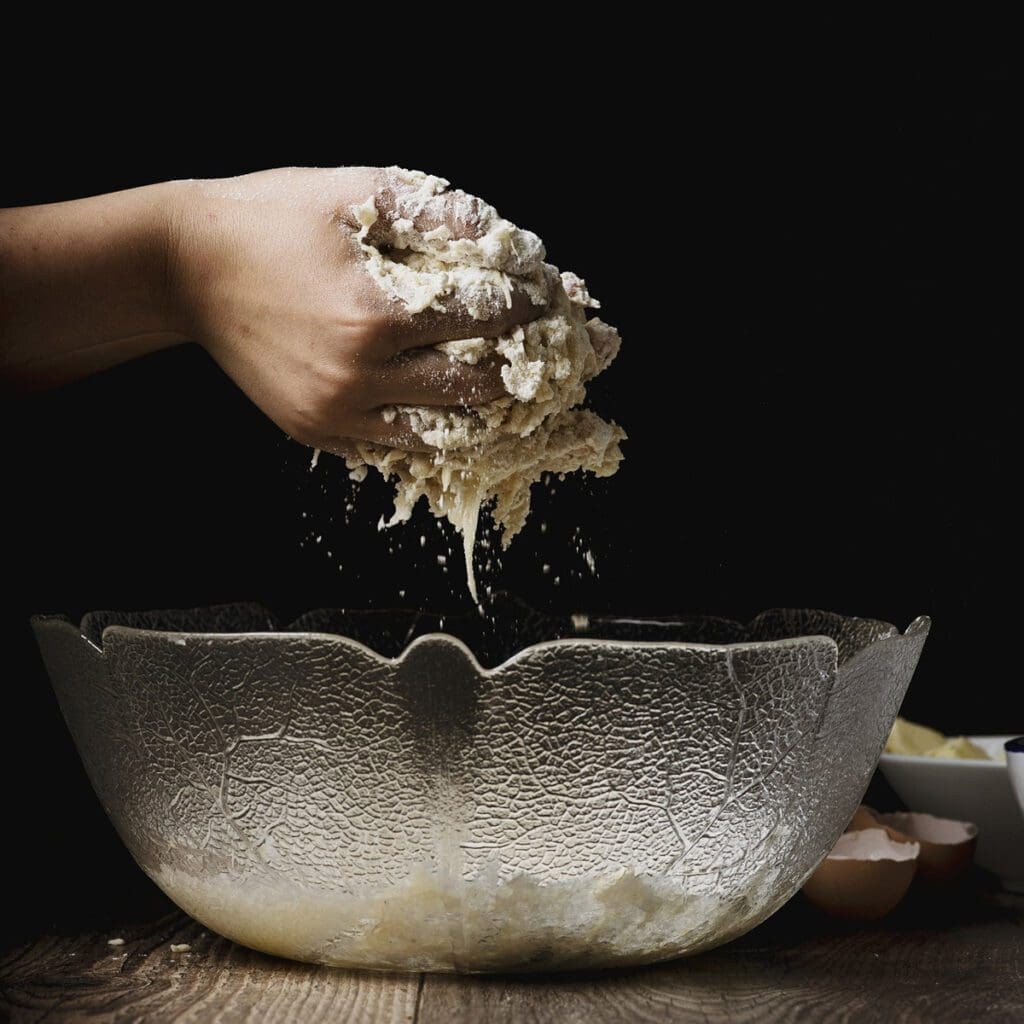 Mixing batter in a bowl with your hands