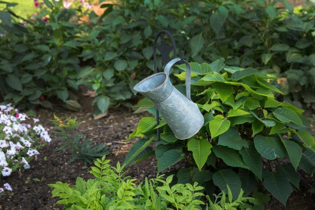 A fancy water jug hanging in lush garden