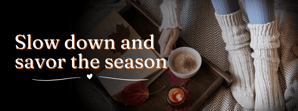 Cozy scene with socks, coffee, book, and candle, accompanied by "Slow down and savor the season" text. Embrace conscious gifting and choose sustainable presents to enrich these tranquil moments.