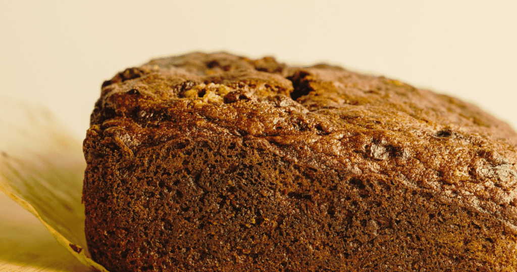 Close-up of freshly baked nettle cake, a foraged treat on parchment paper.