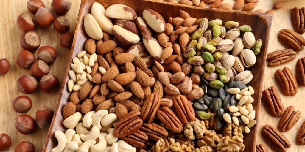 A wooden tray filled with assorted nuts, a wholesome staple of the American diet.