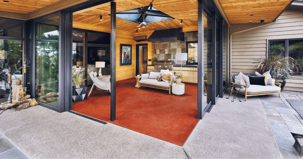 Modern patio with sliding glass doors, lounge chairs, plants, and sustainable subfloors.