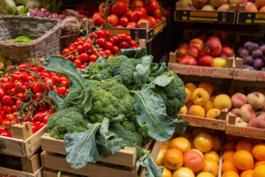 Broccoli, tomatoes, apples, and oranges inspiring awareness for a better world at the market.