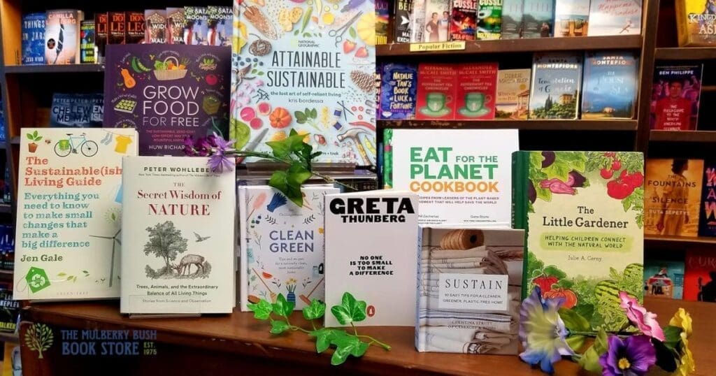 Books about sustainability and gardening at Mulberry Bush Bookstore, decorated with flowers.