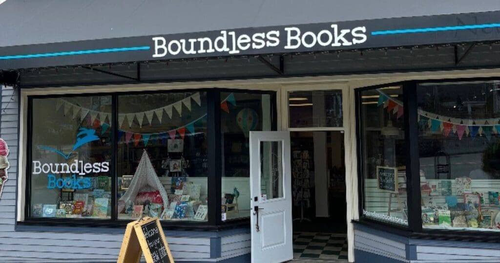 Shopfront of Boundless Books, an independent bookstore with large windows and colorful decor inside.