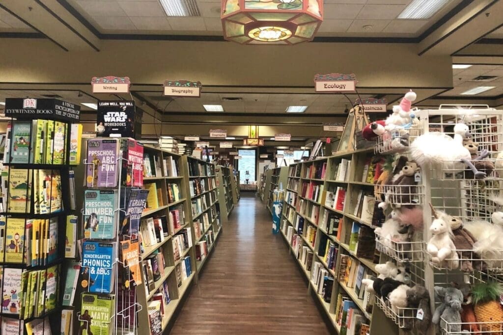 Bookstore aisle at Bolen Books, Victoria, with shelves and plush animals on the right.