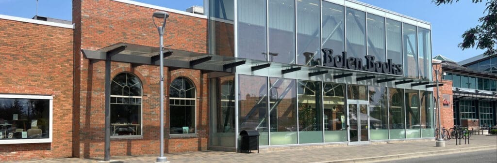 A brick and glass Victoria bookstore with large windows, reminiscent of Bolen Books.